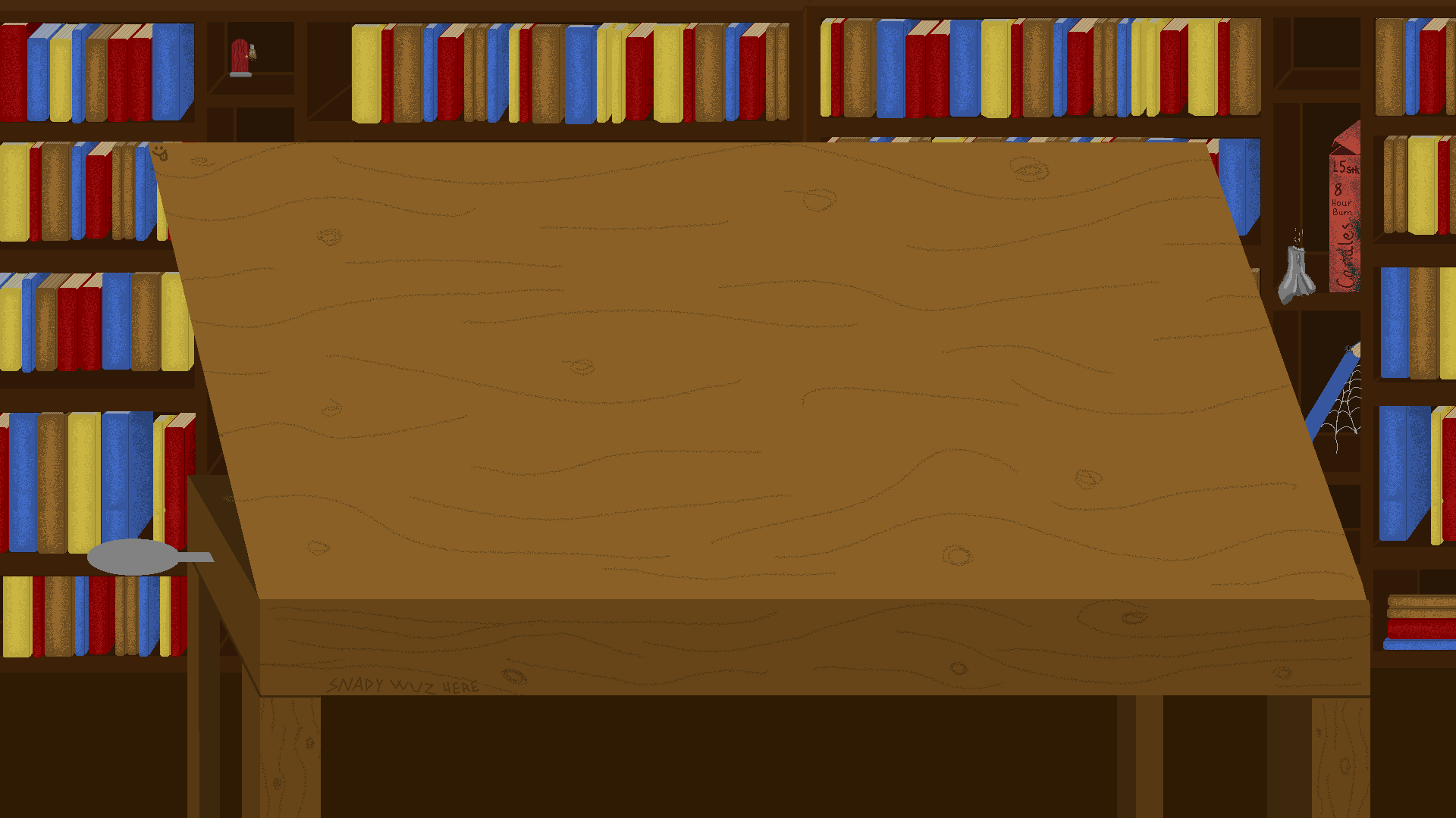 a table in a library. On the table
            is a title, date, authors, and a few pictures 
            of the project itself.